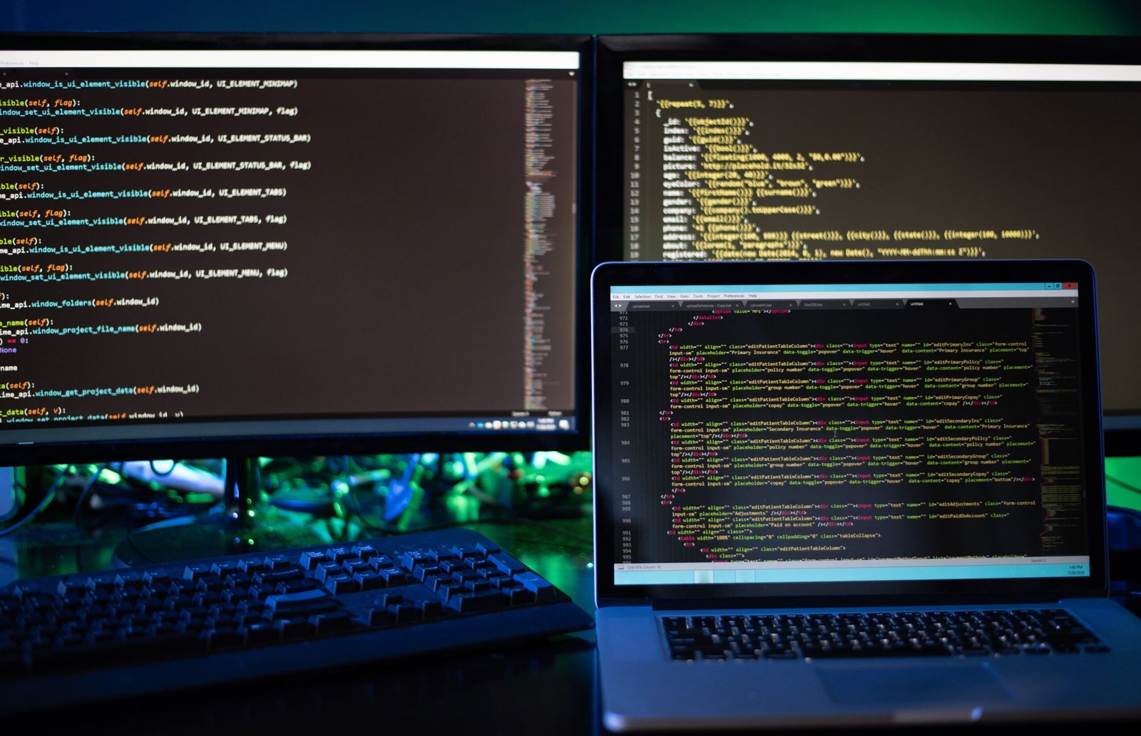 three-computer-screens-with-computer-programming-c-2024-11-01-02-32-20-utc.jpg