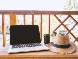 a-laptop-coffee-mug-hat-and-eyeglasses-sit-on-a-2025-02-11-15-53-31-utc-scaled